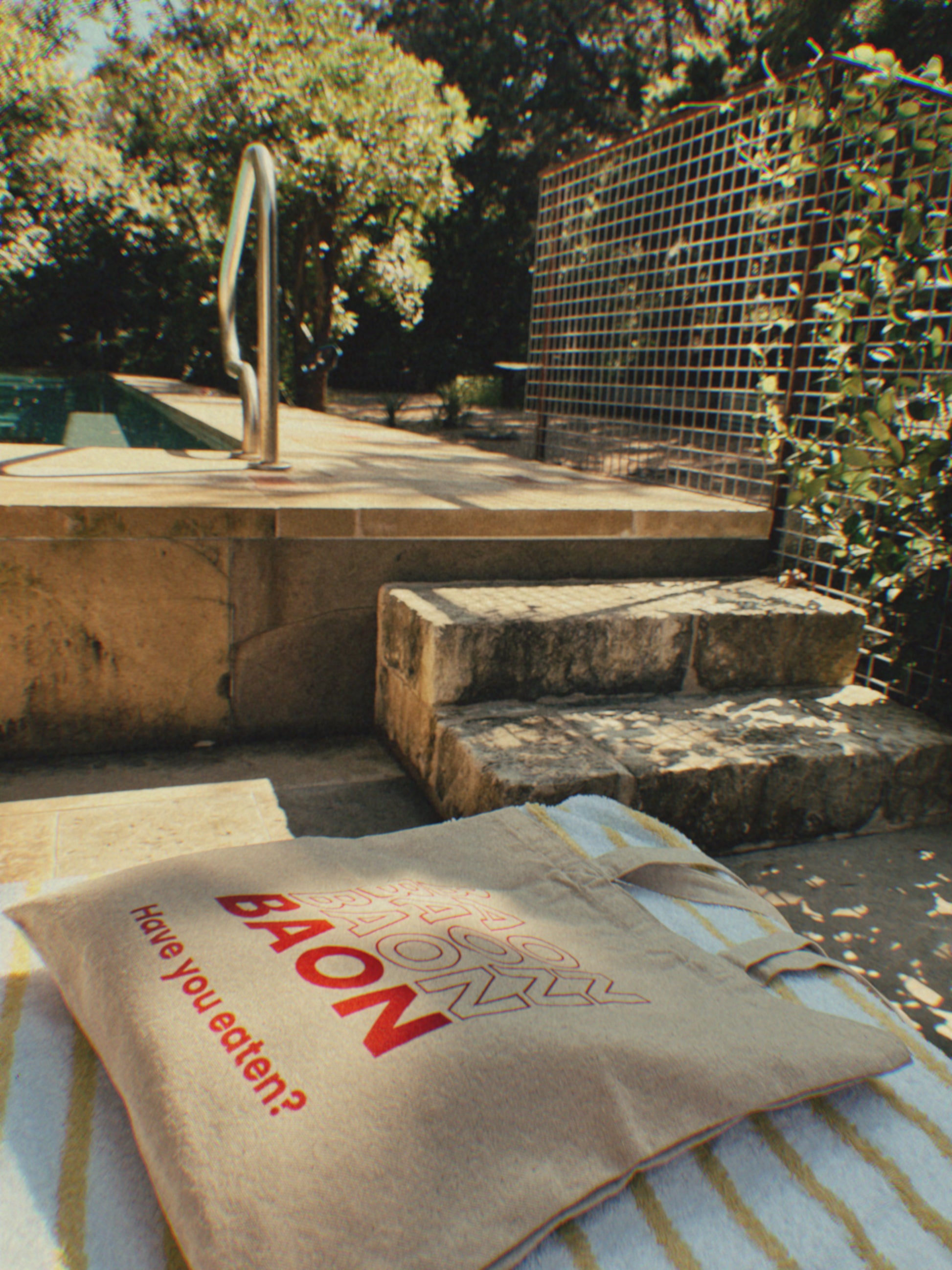 BAON tote on a chair by the pool